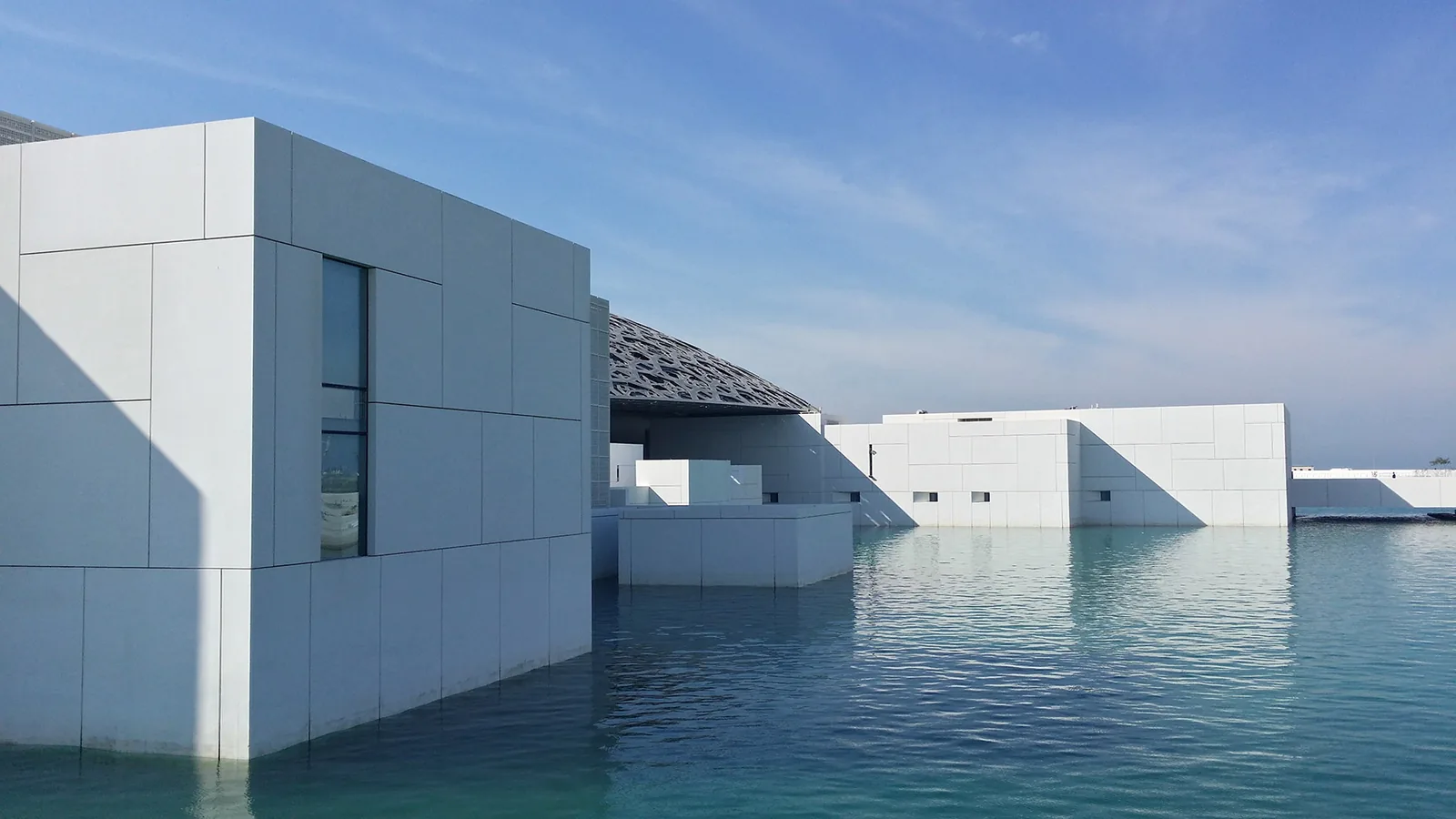 White modern architecture reflected in calm water