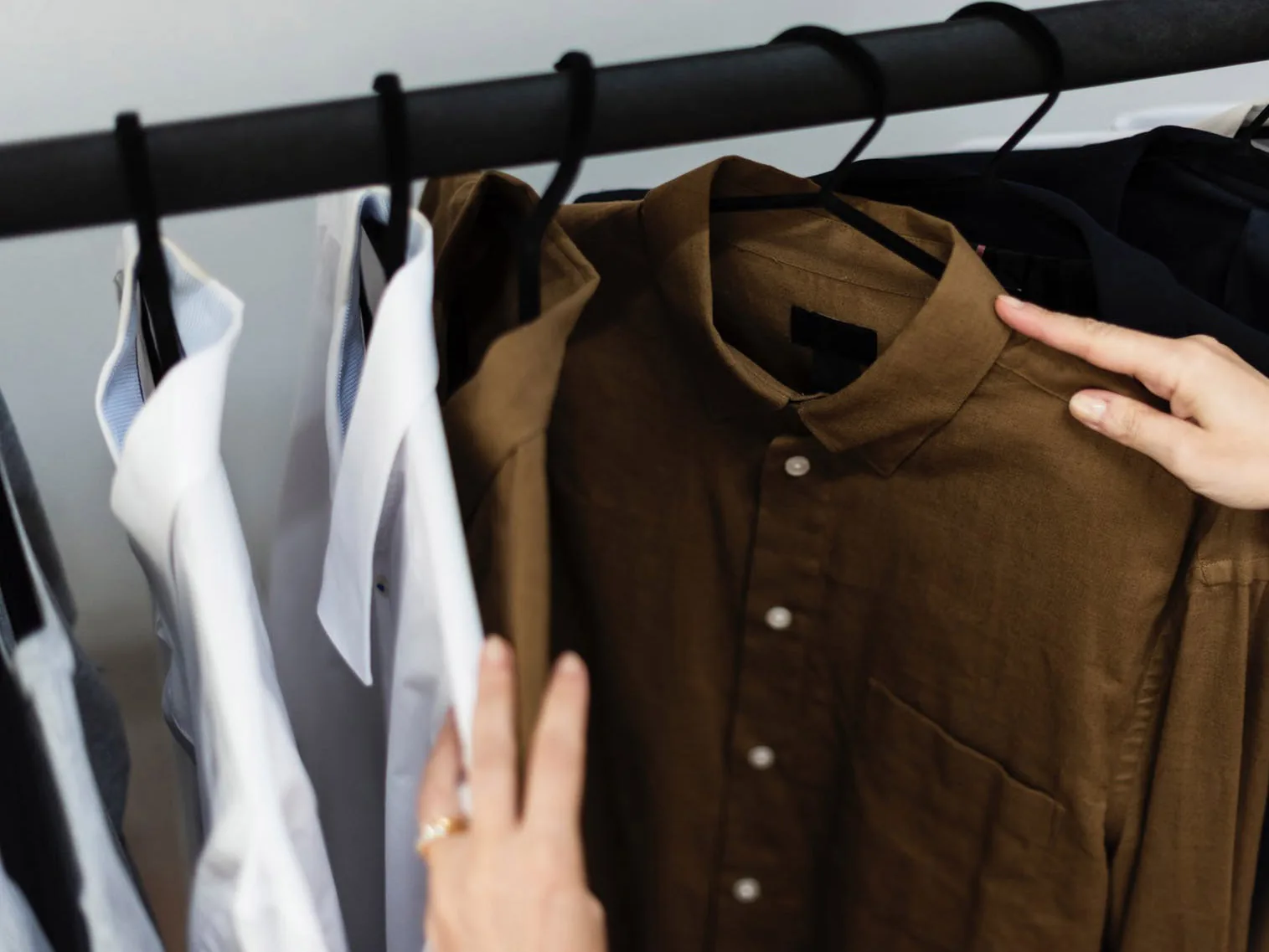 Brown and white shirts displayed on a clothing rack